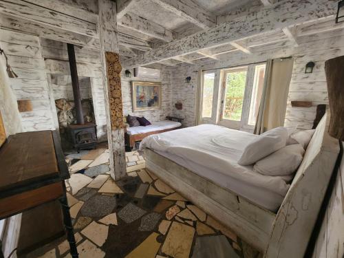 a bedroom with a large bed in a stone wall at Biktot Ba Arafel in Nimrod