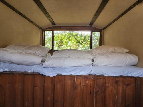 two pillows on a bed in a room with a window at Biktot Ba Arafel in Nimrod