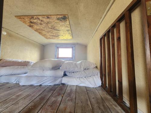 a room with white pillows on the floor at Biktot Ba Arafel in Nimrod
