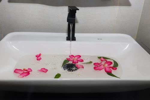 a sink with flowers on it with water in it at Life of Leisure Wilpattu in Pahala Maragahawewa