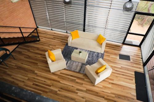 an overhead view of a living room with two couches at Life of Leisure Wilpattu in Pahala Maragahawewa