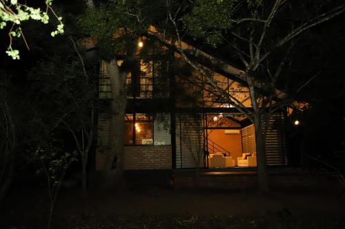 a house lit up at night with lights at Life of Leisure Wilpattu in Pahala Maragahawewa