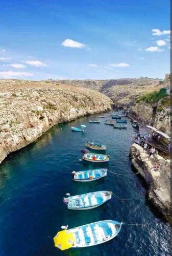 a group of boats sitting in the water at Joseph 2 Stylish flat with open views, just 4km from the airport or beach in Siġġiewi