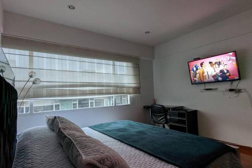 Säng eller sängar i ett rum på APARTAMENTO EN CHICO RESERVADO, PARQUE 93, ZONA T!