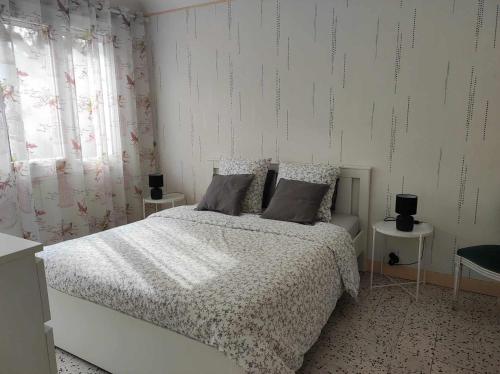 a bedroom with a bed and two night stands at Villa des petites Chaumes in Avallon