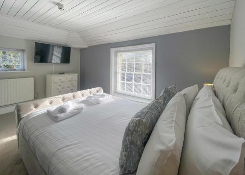a bedroom with a large bed in a room at Haveringland Hall in Cawston