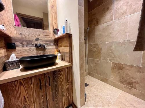 a bathroom with a sink and a shower at Appartement cosy vue montagne in La Clusaz