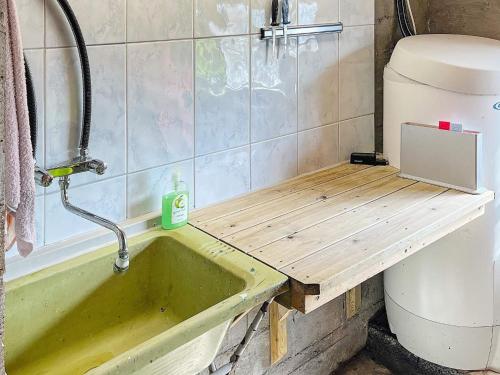 a bathroom with a sink and a toilet at Holiday home Brandasund II in Rolvsnes