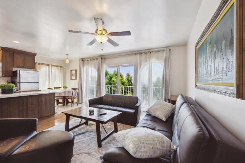 a living room with a couch and a ceiling fan at Charming Retreat on West Quince Street condo in San Diego