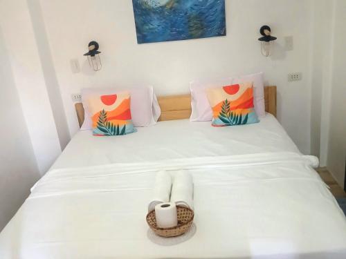 a bedroom with a bed with a basket on it at Strandhaus Condotel in Moalboal