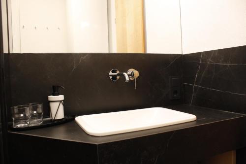 a bathroom with a white sink and a mirror at Haus Schröcker in Gaschurn