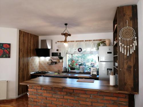 a kitchen with a brick counter and a refrigerator at Pensiunea Transilvania Lodge in Bran