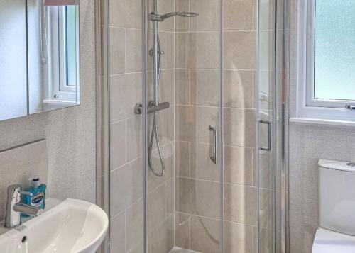 a bathroom with a shower and a sink at Lakeside Luxury Lodges in Thorney