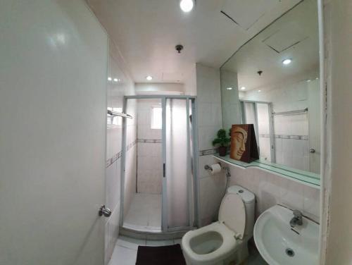 La salle de bains est pourvue d'une douche, de toilettes et d'un lavabo. dans l'établissement Near Manila Airport, MAILZ HOMEZ COZY 2 Bedroom Condo, Full Kitchen, Swimming Pool, WIFI, 4R, à Manille