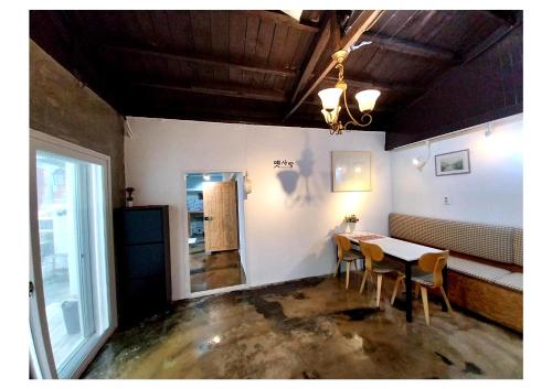 a dining room with a table and chairs at Yeongildae Stay in Pohang