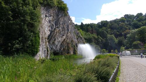 a waterfall on the side of a mountain with a road at Q-time Barvaux, Durbuy-Adults Only in Durbuy