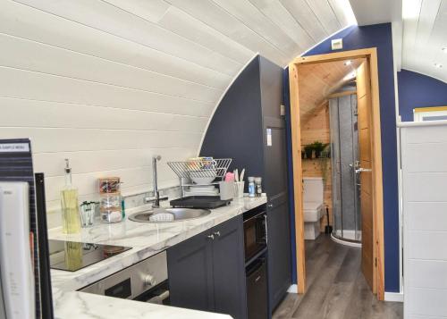 a kitchen with a sink and a counter top at Peacock Lake Glamping in East Bridgford