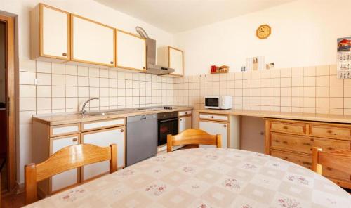 a kitchen with a table and two chairs and a sink at Maribela Apartments in Trogir