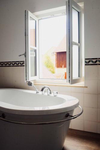 a bath tub in a bathroom with a window at Landhaus am Schloss in Schnabelwaid