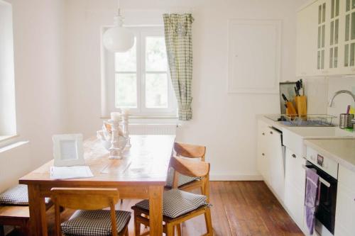 a kitchen with a wooden table and chairs at Landhaus am Schloss in Schnabelwaid