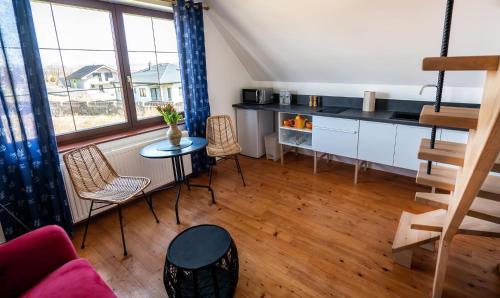 a kitchen with a table and chairs in a room at Tatraview House in Veľká Lomnica