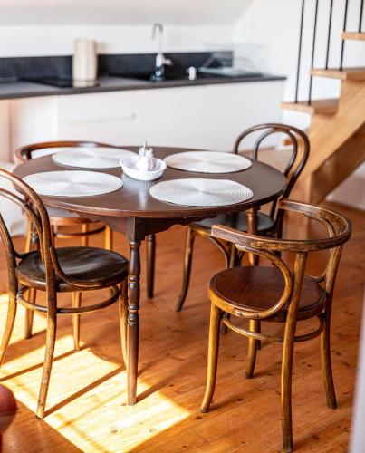 a wooden table and chairs in a kitchen at Tatraview House in Veľká Lomnica