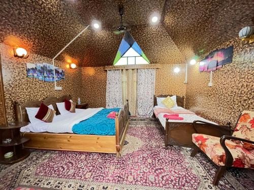 a bedroom with a bed and a couch in a room at New Silver Jubilee Heritage Group Of Houseboats in Srinagar