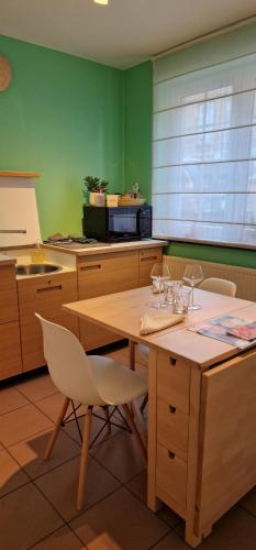 a kitchen with a wooden table and chairs at Bulle D'eau in Spa