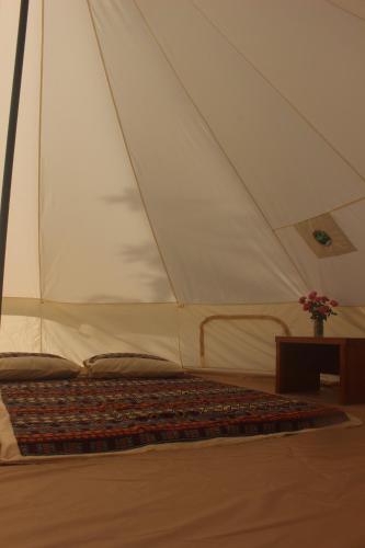 a tent with a bed in a room at Lagom Village (Glamping Site) in Hanoi