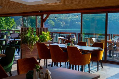 a restaurant with tables and chairs and a large window at Wellness Hotel Vinnay in Vinné