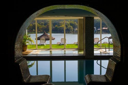 a view of a house with a view of the water at Wellness Hotel Vinnay in Vinné