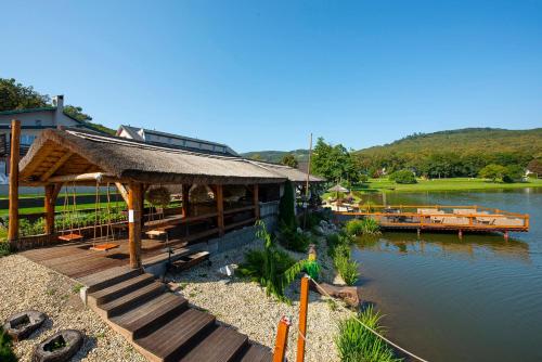 a building with a dock next to a river at Wellness Hotel Vinnay in Vinné