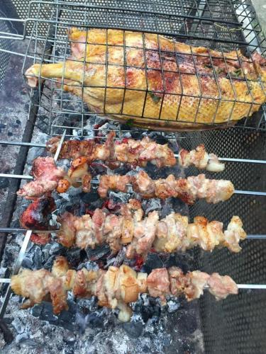a bunch of meat and shrimp on a grill at Lagom Village (Glamping Site) in Hanoi