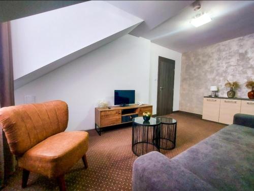 a living room with a bed and a couch and a table at Wellness Hotel Vinnay in Vinné
