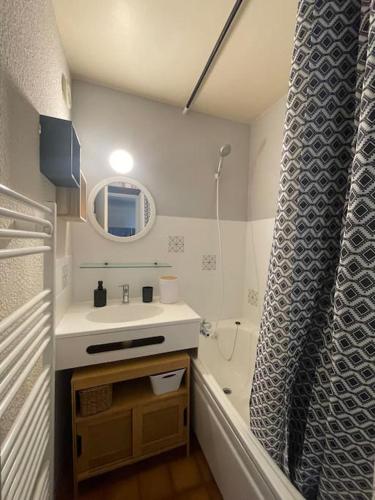 une salle de bain avec un lavabo, un miroir et une douche dans l'établissement Studio Myrtilles du Léman vue sur lac et montagne, à Thollon-les-Mémises