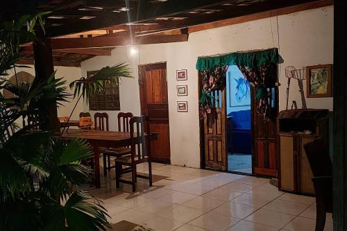 a dining room with a table and a table and chairs at Residencial Maria de Lourdes in Ibicoara
