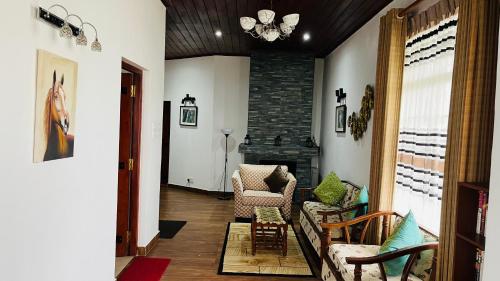 a living room with a couch and a fireplace at Thuring's Holiday Bungalow in Nuwara Eliya