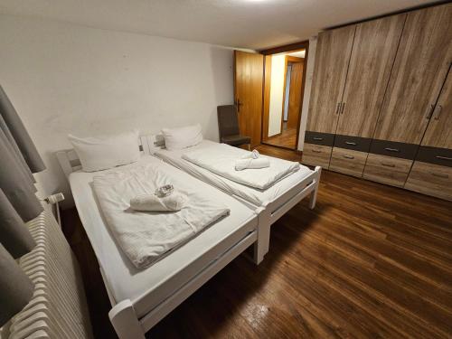 a bedroom with two beds with towels on them at B76, Lauterach, Vorarlberg Apartments in Lauterach