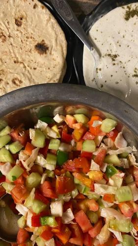 a pot of food with vegetables and a tortilla at Sukha's Place in Pushkar