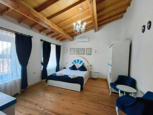 a bedroom with a bed and a wooden ceiling at MAVİ PALAS HOTEL in Buyukada