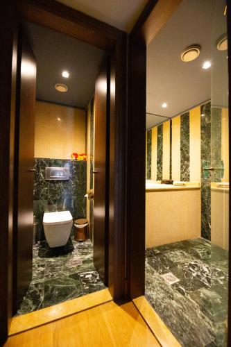 a bathroom with a toilet and a sink at Civitas Suites Hotel in Rethymno Town
