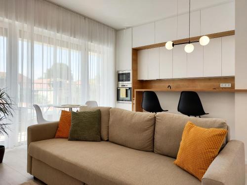 a living room with a couch and a table at Linden Apartman 105 - Adults Only in Mosonmagyaróvár
