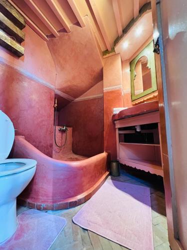 a bathroom with a tub and a toilet and a sink at Riad Al Nour in Marrakech