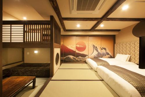 a bedroom with a bed and a painting on the wall at Centurion Hotel Ueno in Tokyo
