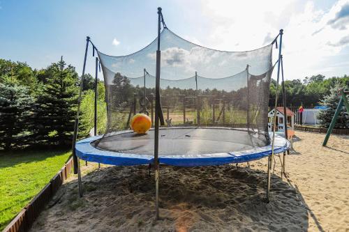 a small trampoline in the sand in a park at Bednarzówka in Nowy Tomyśl