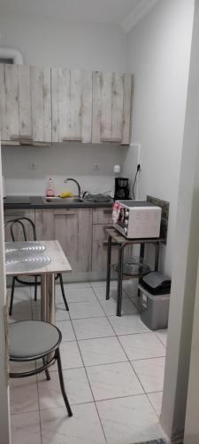 a kitchen with a table and chairs and a stove at ANASTASIA studio in Kavala