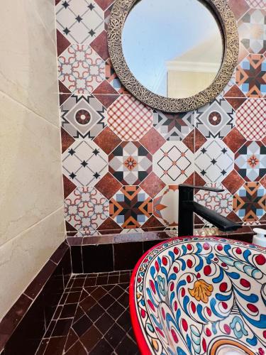 a bathroom with a sink and a mirror at Riad Al Nour in Marrakech