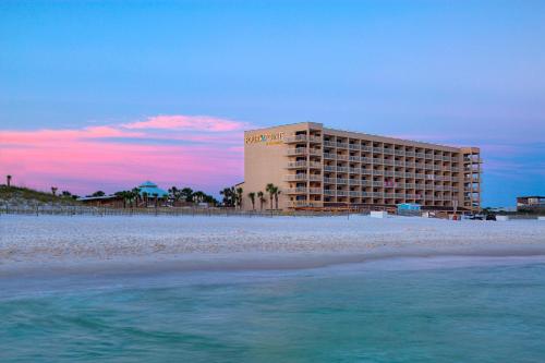 a hotel on the beach next to the ocean at Four Points by Sheraton Destin - Fort Walton Beach in Fort Walton Beach