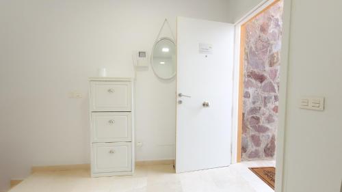 a white room with a dresser and a mirror at Amazing cozy Villa Hugo Tauro with Jacuzzi, Pool, Wi-Fi in Mogán