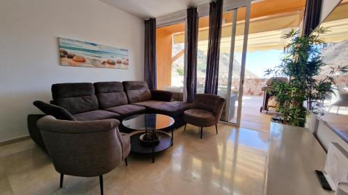 a living room with a couch and chairs and a table at Amazing cozy Villa Hugo Tauro with Jacuzzi, Pool, Wi-Fi in Mogán